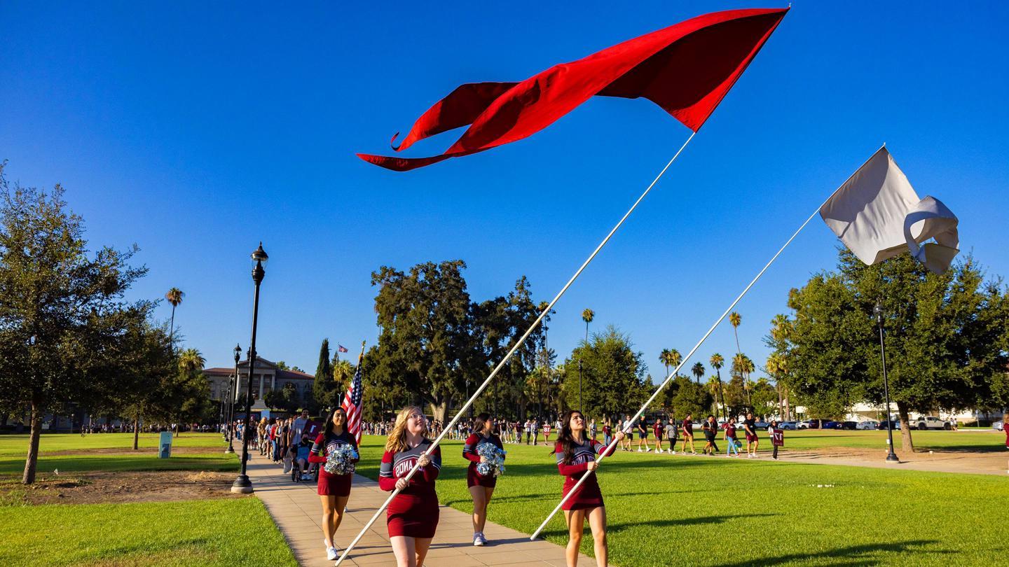 Media masthead - Flags and banners at new student orientation convocation event